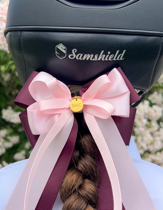 Burgundy and pink horse show bow for jumper riders