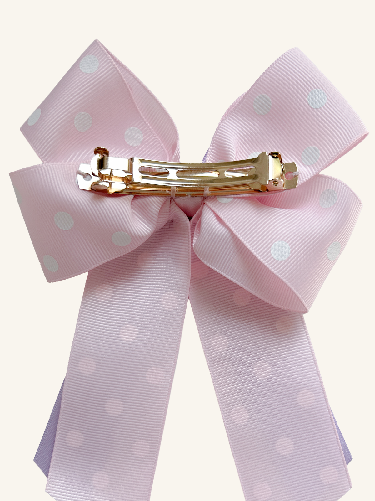 Back of Rainbow Wishes horse show bow showing the gold French barrette