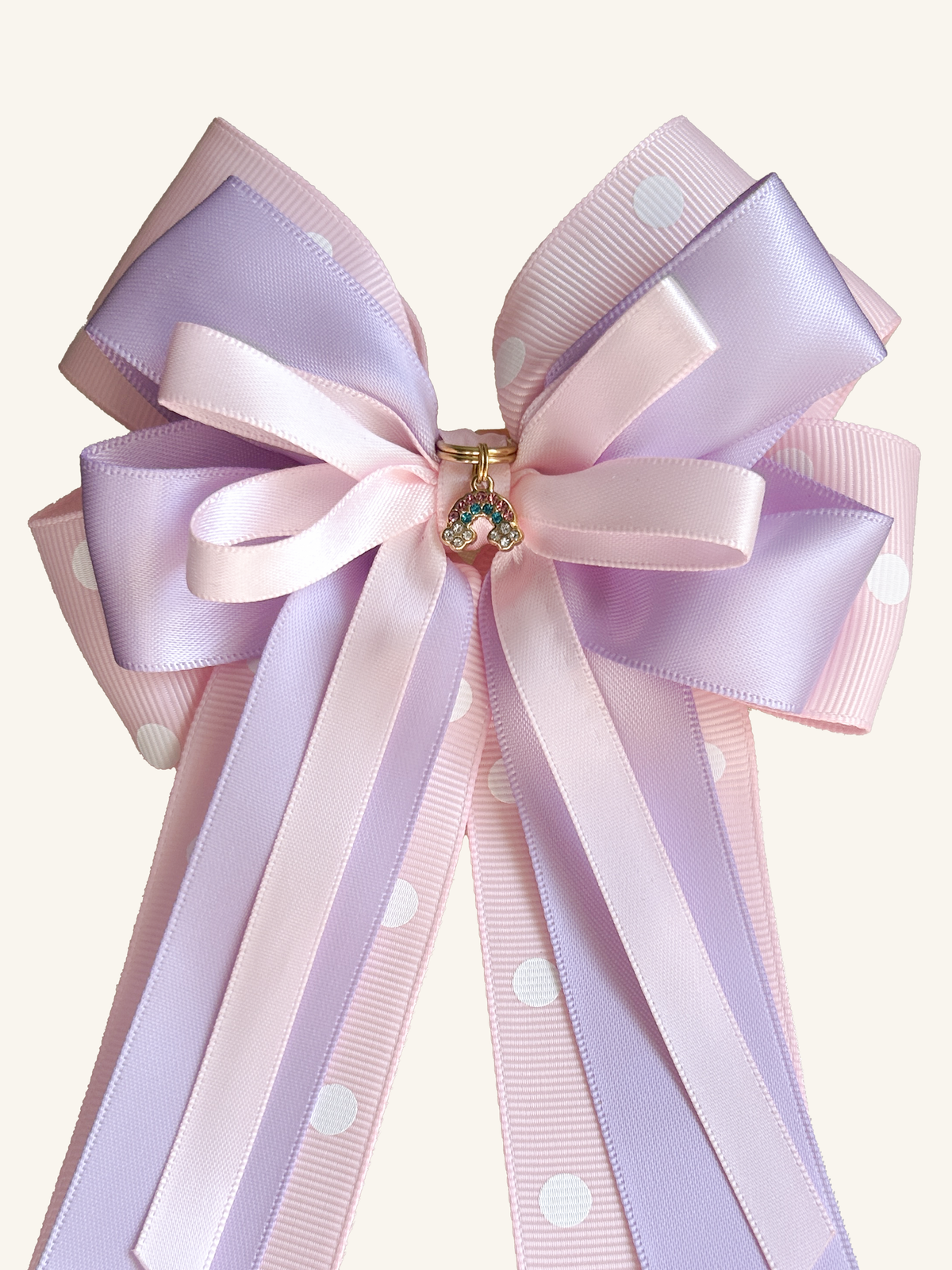 Rainbow Wishes horse show bow with lilac satin, pink polka-dot ribbon and sparkling rainbow charm