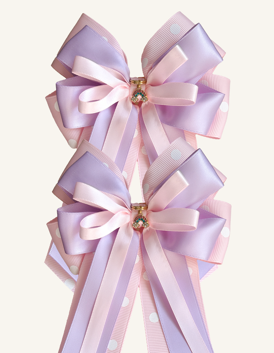 Pair of Rainbow Wishes pink and lilac equestrian show bows with rainbow charms