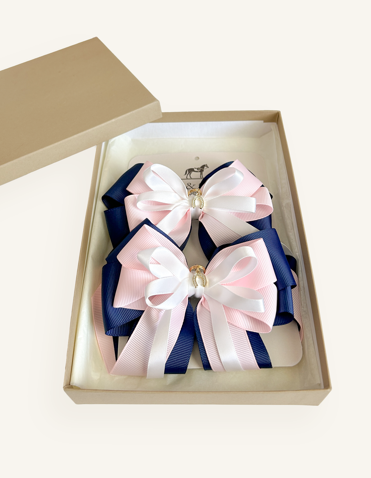 Royal Blush pink, navy and white equestrian show bows presented as a matching pair
