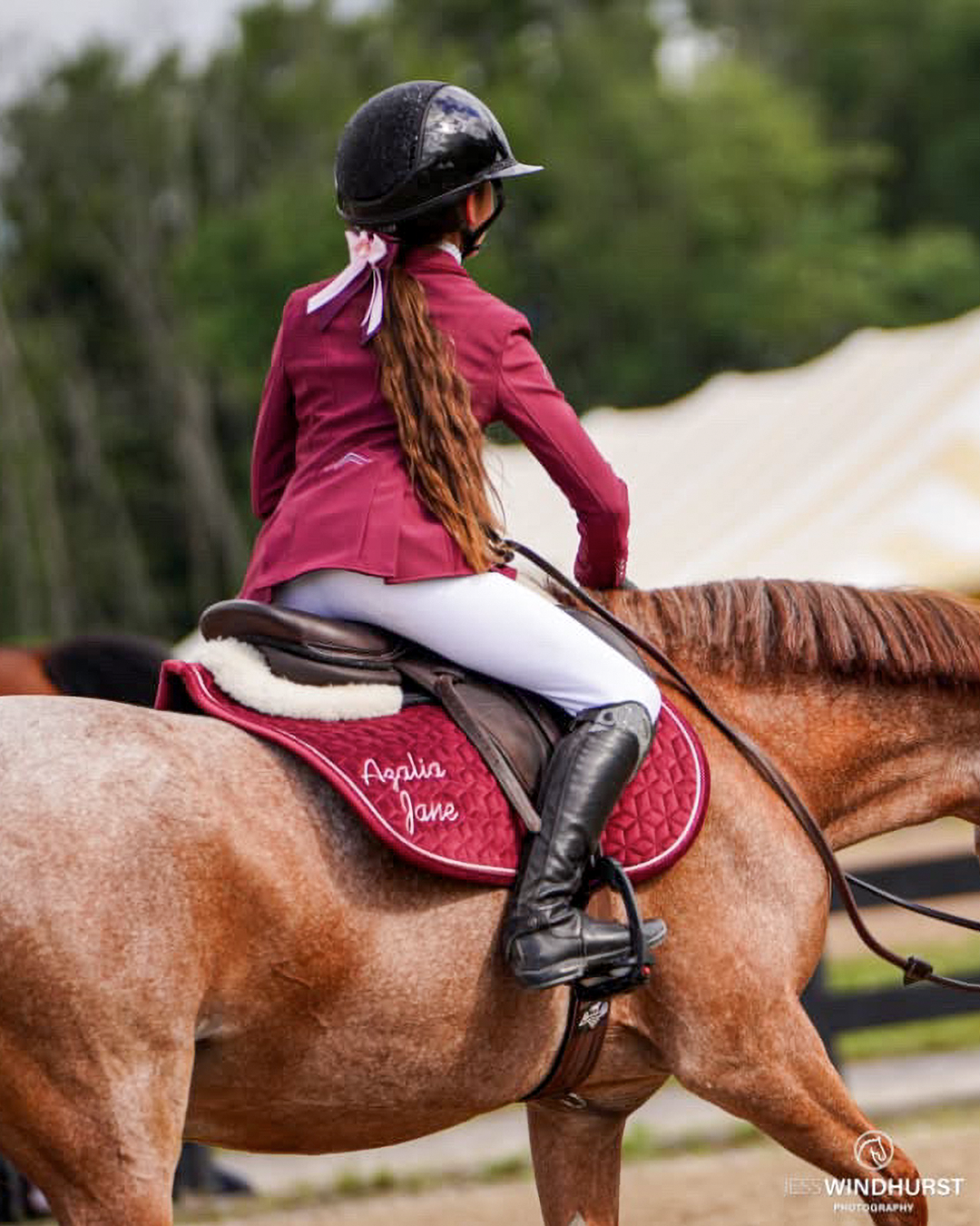 Young equestrian rider wearing Bows & Charms horse show bows